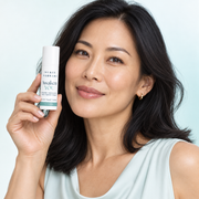 East Asian woman in her late 30s holding the exact capped Awaken YOU eye gel-cream