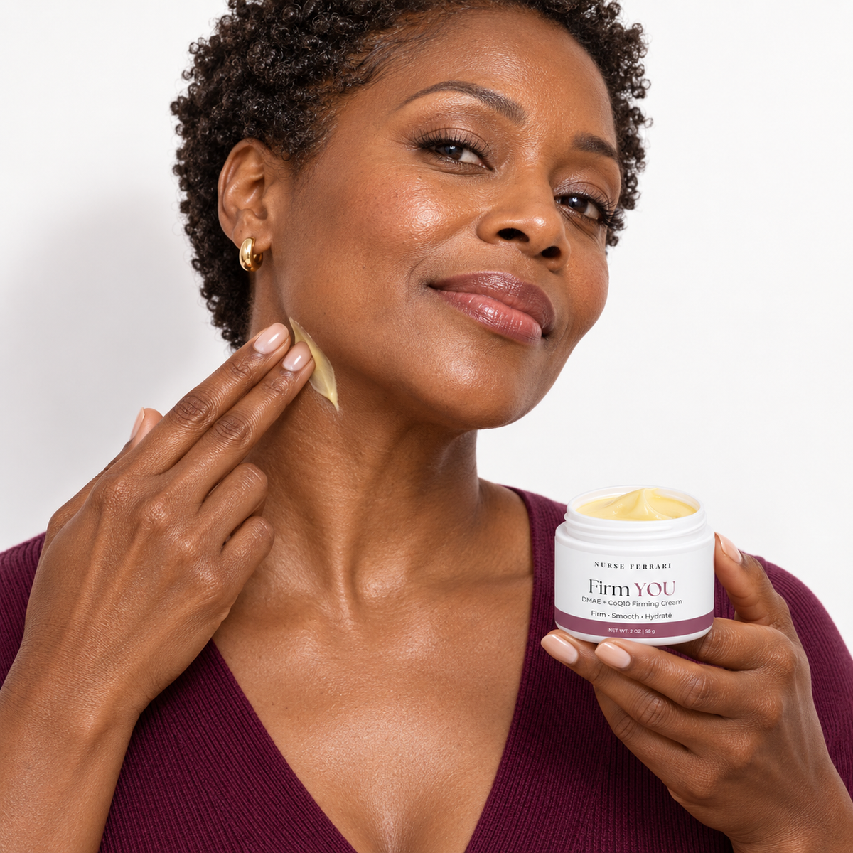 Black woman applying Firm YOU cream upward along her neck