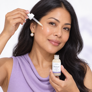 Filipina woman applying pale-ivory Illuminate YOU serum with the correct white dropper
