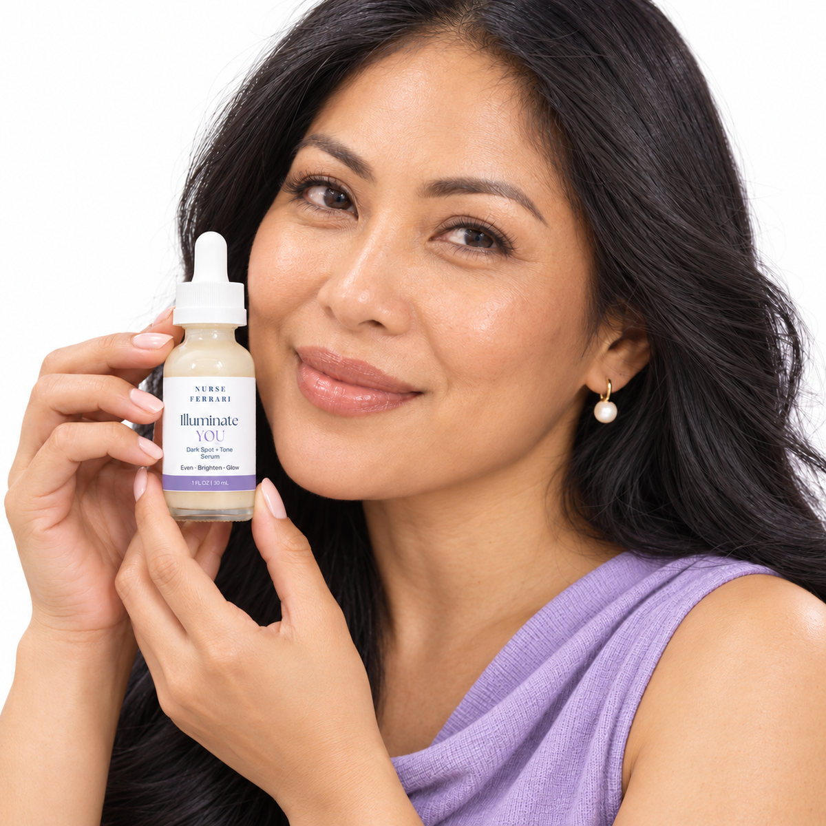Woman holding Illuminate YOU serum on white