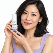 East Asian woman in her late 30s holding Refine YOU 10 percent niacinamide serum
