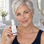 Woman with short silver hair holding Timeless YOU night moisturizer